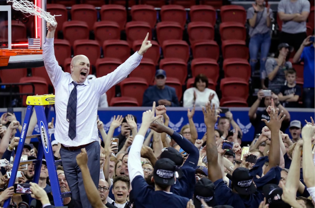 Utah State's head coach Craig Smith cuts off the net following an NCAA college basketball game against San Diego State for the Mountain West Conference men's tournament championship Saturday, March 7, 2020, in Las Vegas. (AP Photo/Isaac Brekken)