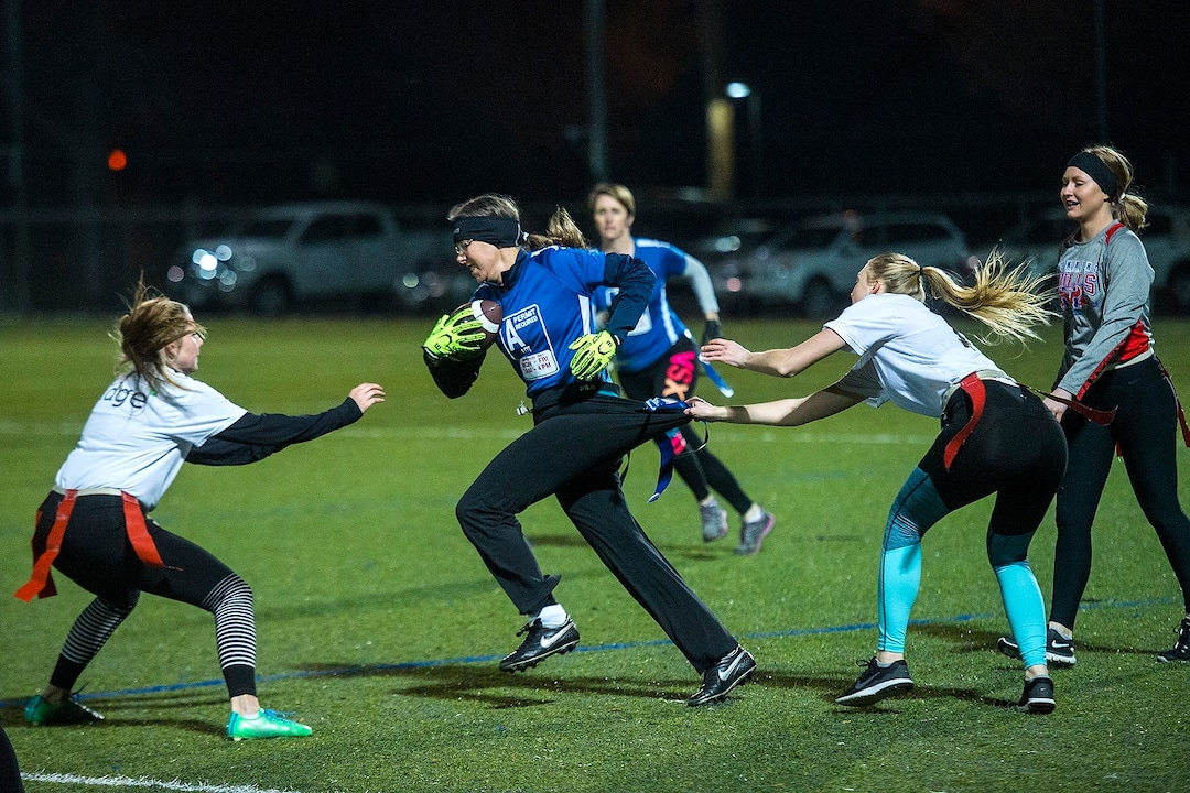 (Chris Detrick  |  The Salt Lake Tribune) Team A Lot's Denise Stephens runs the ball during the flag football team game against Sim Team at North University Fields in Provo Thursday, November 30, 2017.  