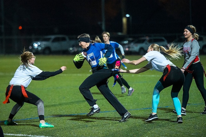 (Chris Detrick | The Salt Lake Tribune) Team A Lot's Denise Stephens runs the ball during the flag football team game against Sim Team at North University Fields in Provo Thursday, November 30, 2017.