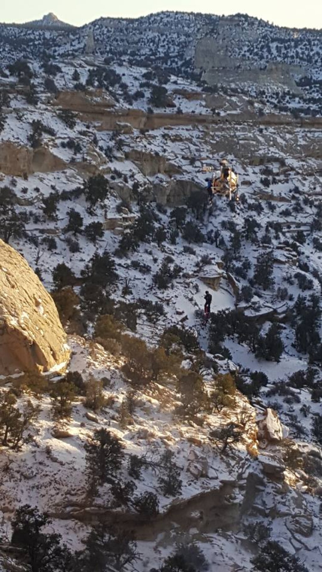 (Courtesy the Emery County Sheriff's Office) A Department of Public Safety crew member descends from a helicopter to find the body of Reynaldo Andico, 53. Andico, of California, went missing in October 2017. His body, and the body of two dogs he was traveling with, were found Friday, Dec. 22, 2017, in the San Rafael Desert.