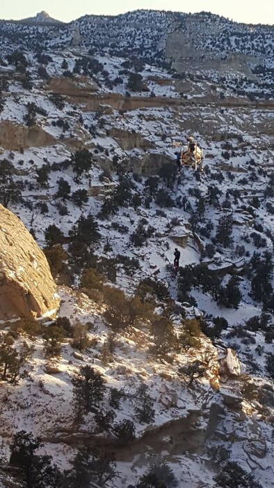 (Courtesy the Emery County Sheriff's Office) A Department of Public Safety crew member descends from a helicopter to find the body of Reynaldo Andico, 53. Andico, of California, went missing in October 2017. His body, and the body of two dogs he was traveling with, were found Friday, Dec. 22, 2017, in the San Rafael Desert.