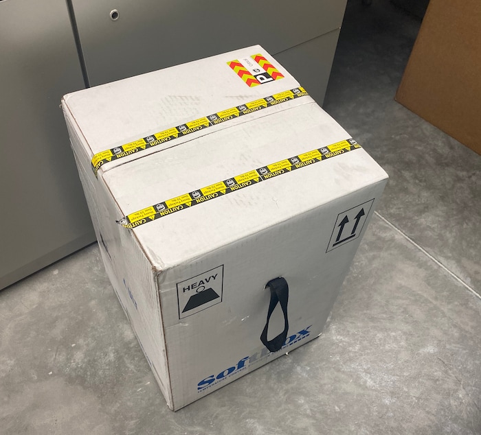 (Photos courtesy Intermountain Healthcare) An employee at Utah Valley Hospital in Provo unboxes the state of Utah's first batch of COVID-19 vaccine, on Monday, Dec. 14, 2020. The vaccine, developed by Pfizer Inc. and BioNTech, must be stored at around 95 degrees below zero Fahrenheit, so it is shipped surrounded by dry ice and stored in a supercold freezer.