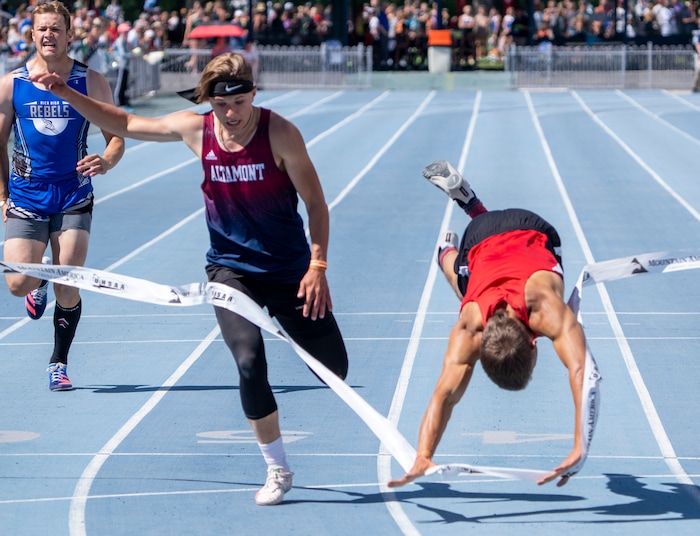 (Rick Egan | The Salt Lake Tribune)  Altamont's Ethan Hansen finishes in second place as Blake Barnes dives headfirst into the finish line for a first place finish in the 1A Boys 200 meter dash, at the State High School Championships at BYU, on Saturday, May 21, 2022.

