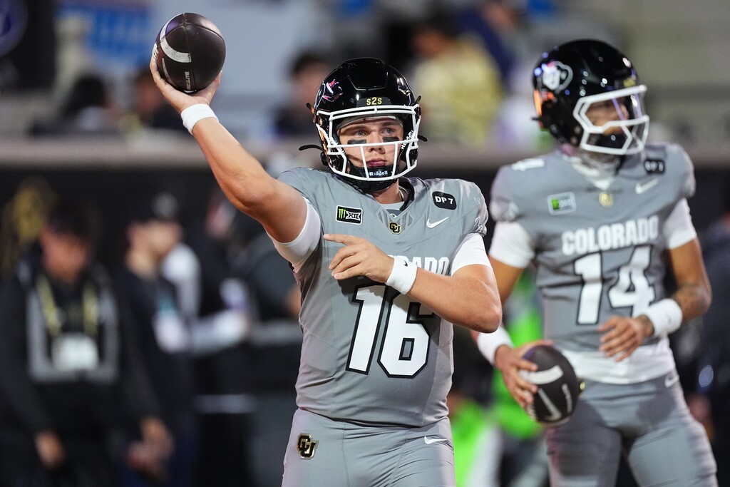 Colorado quarterbacks Isaac Wilson, front, and Kaneal Sweetwyne warm up before an NCAA college football game against Utah Saturday, Oct. 17 2026, in Boulder, Colo. (AP Photo/David Zalubowski)