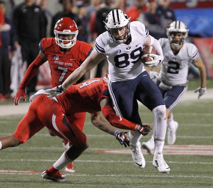 BYU's tight end Matt Bushman runs past Fresno State's Mike Bell during the second half of an NCAA college football game in Fresno, Calif., Saturday, Nov. 4, 2017. Fresno State won the game 20-13. (AP Photo/Gary Kazanjian)