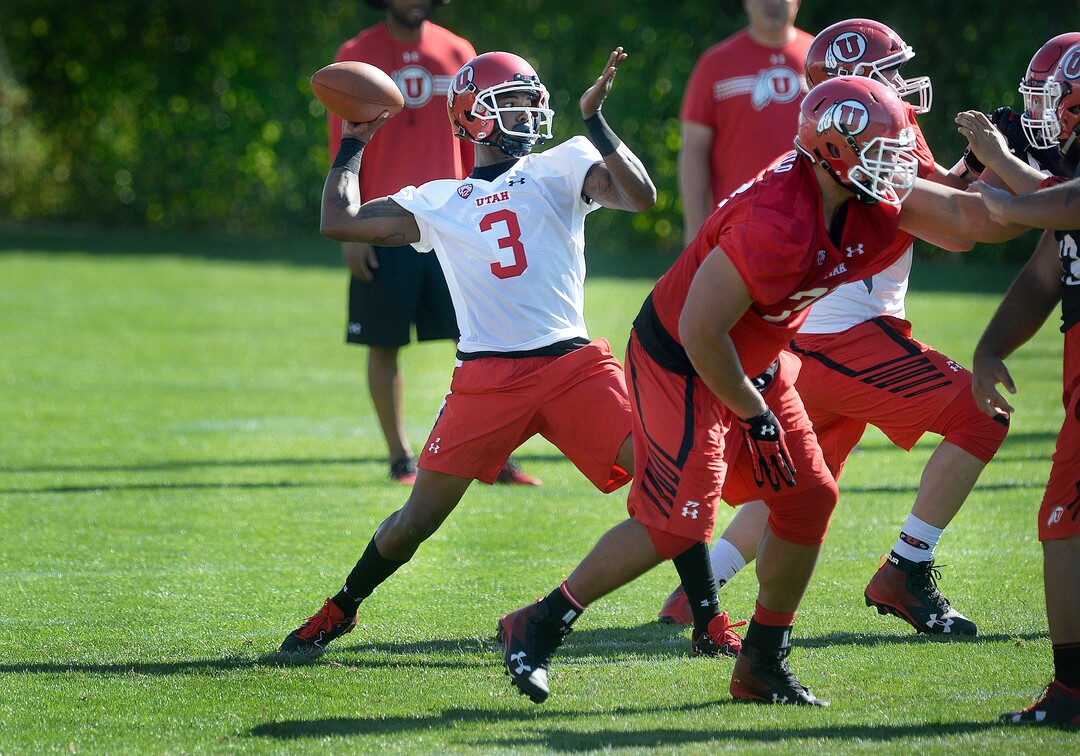 Utah quarterback Troy Williams passes behind protection from the offensive line during the first day of NCAA college football practice for the team Friday, July 28, 2017, in Salt Lake City. (Scott Sommerdorf/The Salt Lake Tribune via AP)