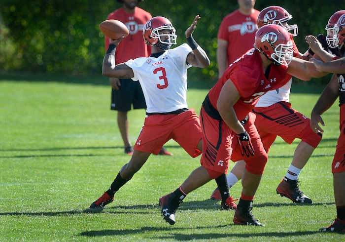 Utah quarterback Troy Williams passes behind protection from the offensive line during the first day of NCAA college football practice for the team Friday, July 28, 2017, in Salt Lake City. (Scott Sommerdorf/The Salt Lake Tribune via AP)