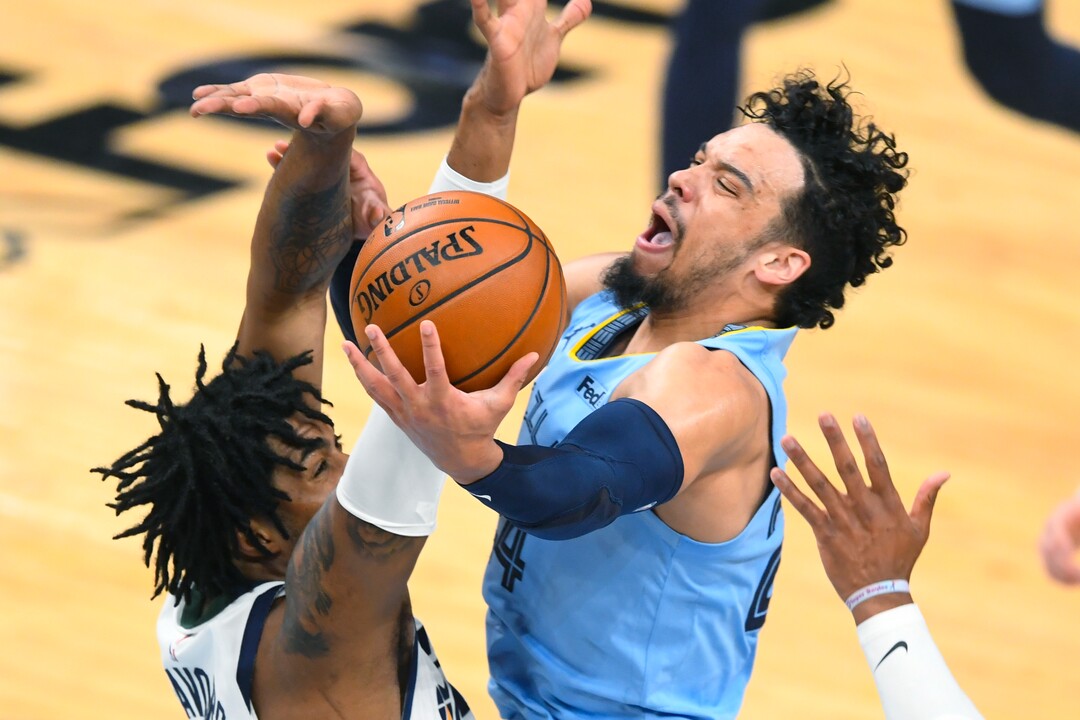 Memphis Grizzlies forward Dillon Brooks, right, goes to the basket as Utah Jazz center Derrick Favors defends during the first half of Game 3 of an NBA basketball first-round playoff series Saturday, May 29, 2021, in Memphis, Tenn. (AP Photo/John Amis)
