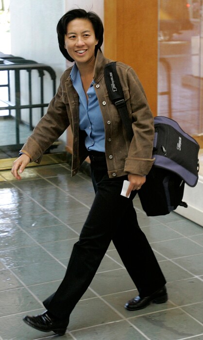 FILE - In this Nov. 5, 2007 file photo, Los Angeles Dodgers assistant general manager Kim Ng walks through the hotel lobby during the first day of Major League Baseball annual general managers meetings in Orlando, Fla. Ng has become the highest-ranking woman in baseball operations in the major leagues. She was hired Friday, Nov. 13, 2020, as general manager of the Miami Marlins. (AP Photo/John Raoux, file)