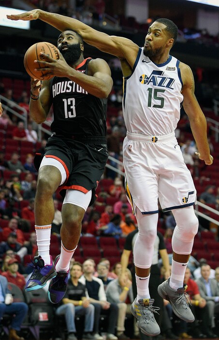 Houston Rockets guard James Harden (13) drives to the basket as Utah Jazz forward Derrick Favors defends during the first half of an NBA basketball game, Wednesday, Oct. 24, 2018, In Houston. (AP Photo/Eric Christian Smith)