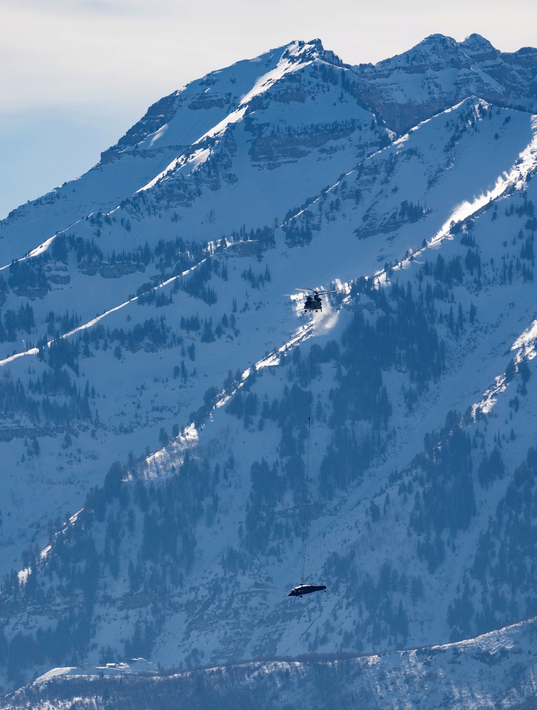 (Francisco Kjolseth | The Salt Lake Tribune) Recovery operations for two Utah Army National Guard UH-60 Black Hawk helicopters involved in a training accident in the Mineral Basin area last week are performed by a CH-47 Chinook helicopter and brought to the Heber Valley Airport on Wednesday, March 2, 2022.