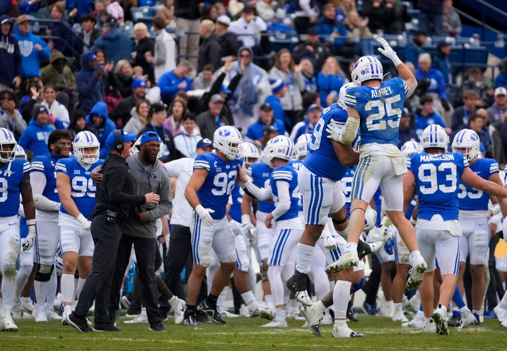 (Bethany Baker | The Salt Lake Tribune) Brigham Young Cougars celebrate a turnover against the Oklahoma Sooners at LaVell Edwards Stadium in Provo on Saturday, Nov. 18, 2023.