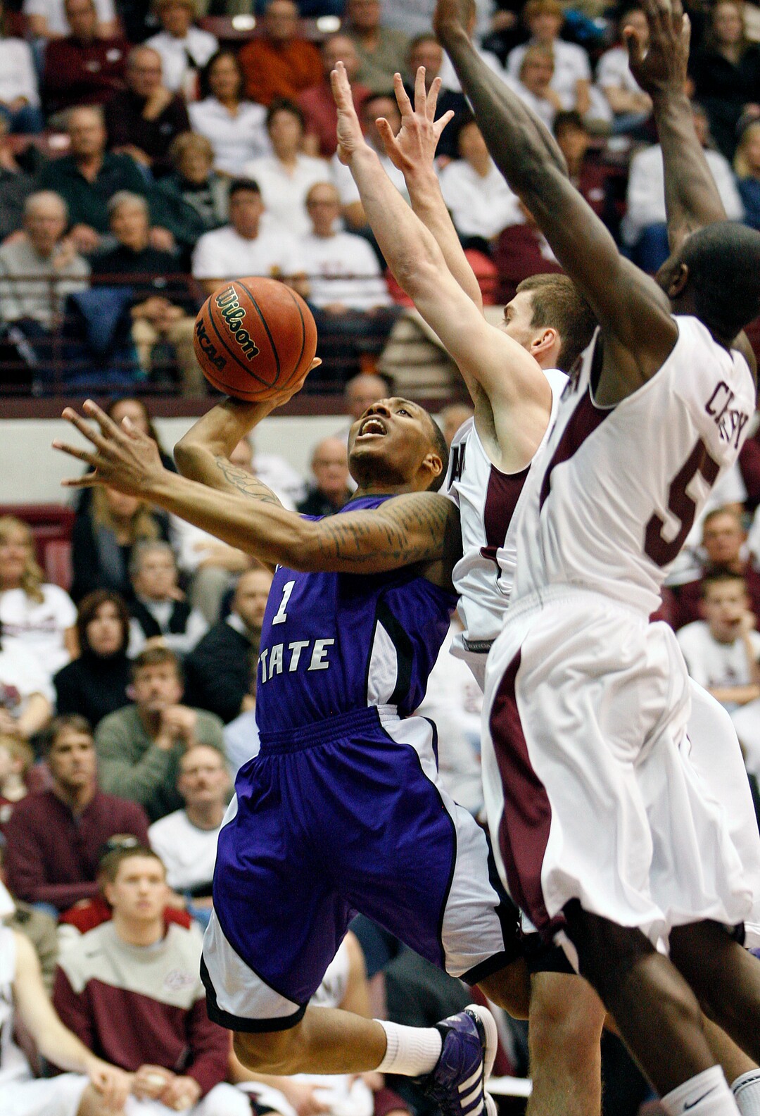 (Michael Albans  |  AP file photo)  Weber State guard Damian Lillard (1) goes up under the basket in front of Montana guard Will Cherry (5) and forward Mike Weisner, center,  during the first half of a 2012 NCAA college basketball game in Missoula, Mont.