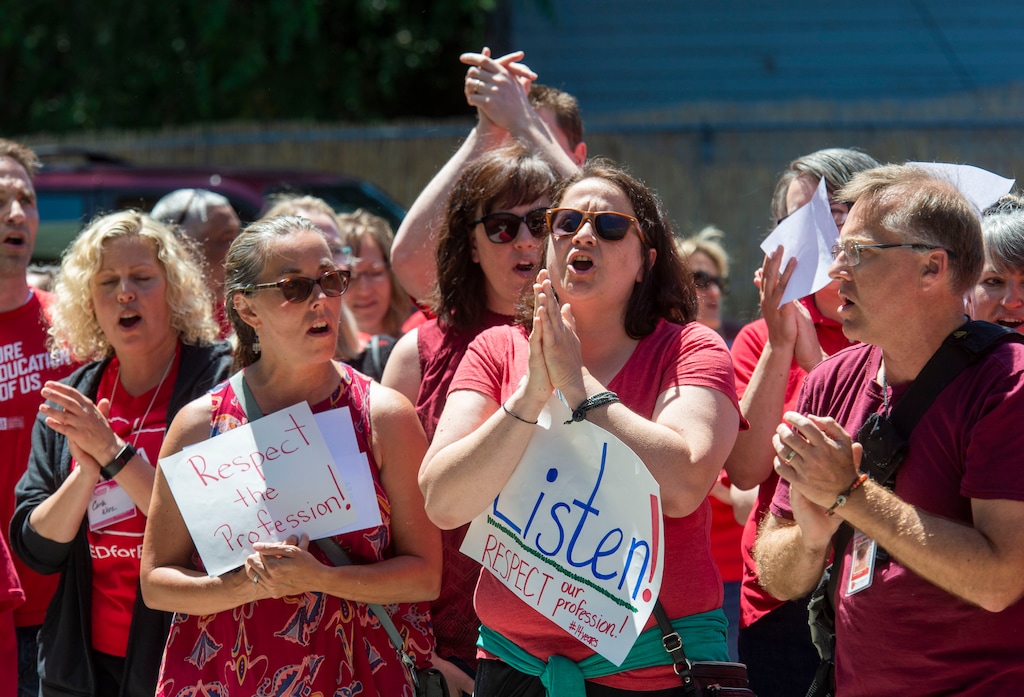 (Rick Egan  |  The Salt Lake Tribune)      Kirsten Oliver and Lena Foster chant with teachers from the Salt Lake School District,  during a rally at Innovations High School, Tuesday, June 18, 2019.