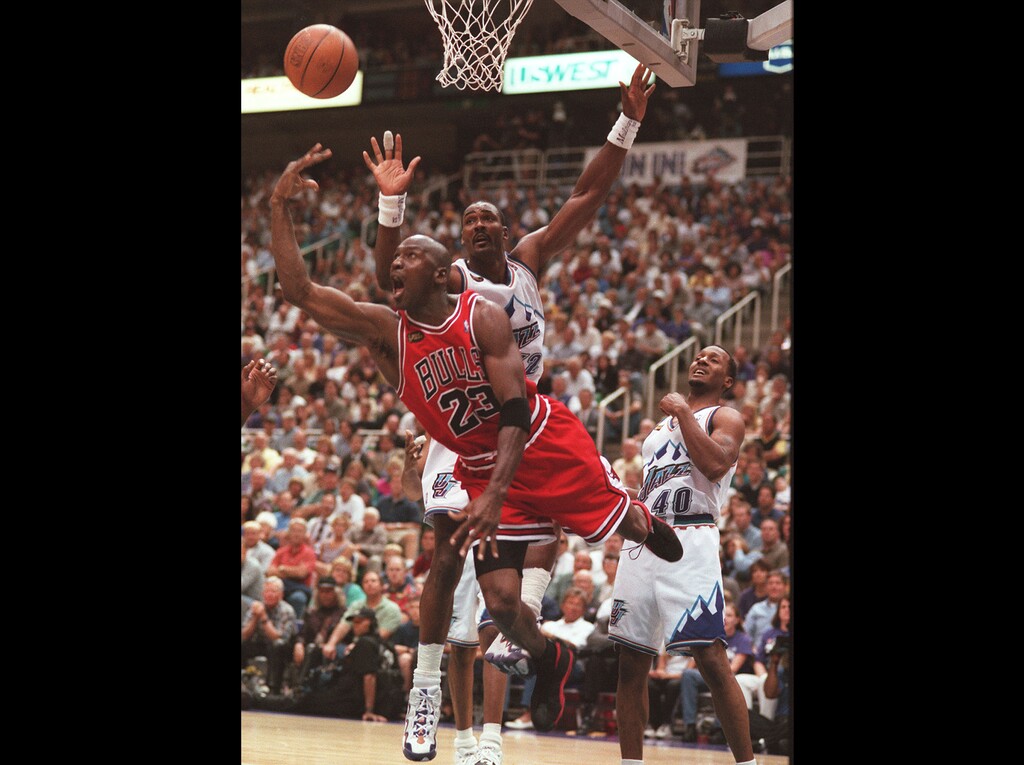 (Trent Nelson | Tribune file photo) Chicago Bulls guard Michael Jordan (23) attempts a shot going past Utah Jazz forward Karl Malone (32) during Game 1 of the 1998 NBA Finals at the Delta Center in Salt Lake City, June 3, 1998.