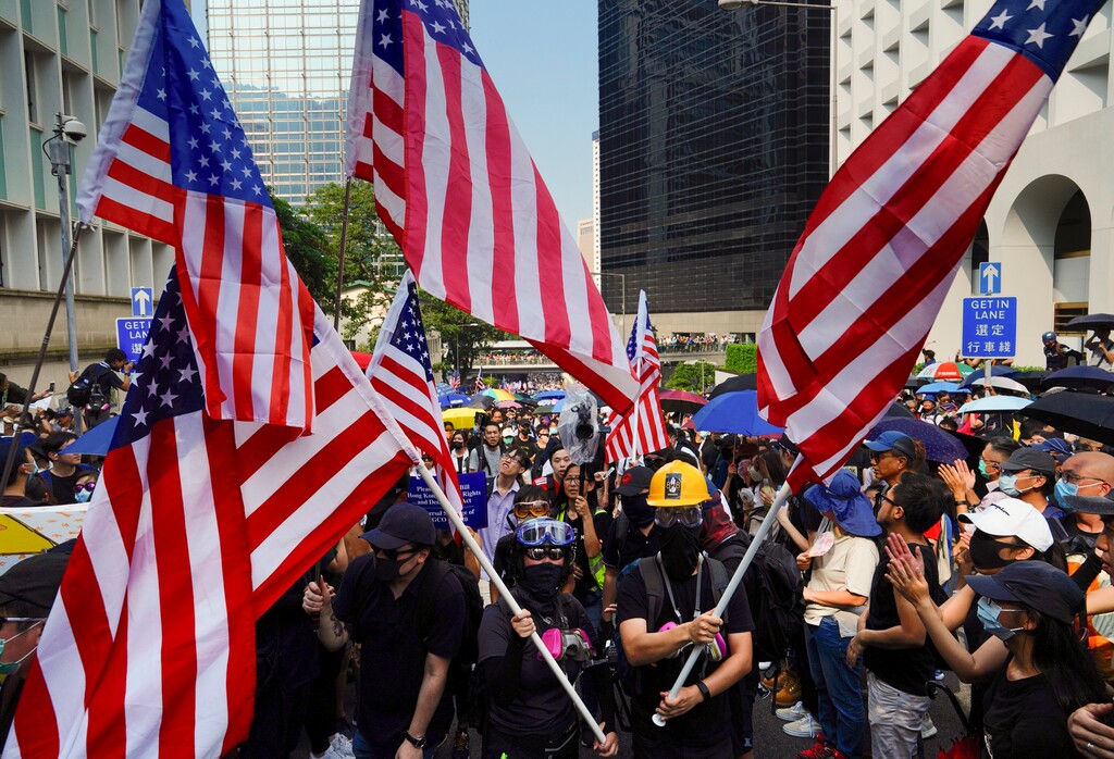 (Vincent Yu | AP) Protesters shout slogans and wave U.S. flags as they march from Chater Garden to the U.S. Consulate in Hong Kong, Sunday, Sept. 8, 2019. Demonstrators in Hong Kong plan to march to the U.S. Consulate on Sunday to drum up international support for their protest movement, a day after attempts to disrupt transportation to the airport were thwarted by police.