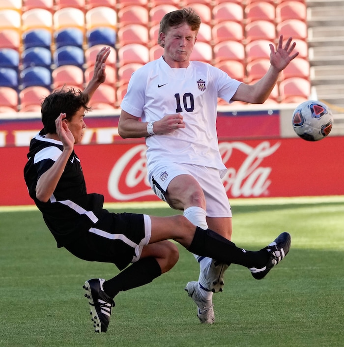 (Francisco Kjolseth | The Salt Lake Tribune) Davis's Luke Bitner (3) collides with Herriman's Grant Taylor (10) during their 6A State Soccer Championship title game at Rio Tinto Stadium, Wednesday, May 25, 2022. Herriman defeated Davis 1-0 with two seconds left on the clock.