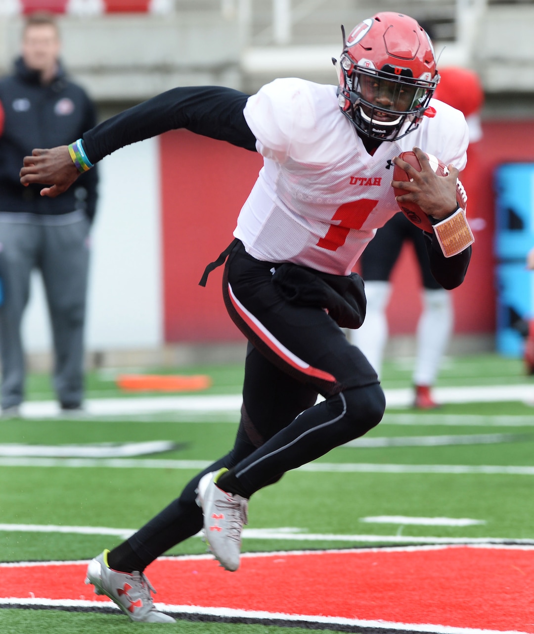 Steve Griffin  |  The Salt Lake TribuneUtah freshman quarterback Tyler Huntley sprints away from the pass rush during spring football practice at Rice-Eccles Stadium in Salt Lake City, Tuesday, March 29, 2016. Huntley and Simpkins both attended Hallandale High School in Florida.