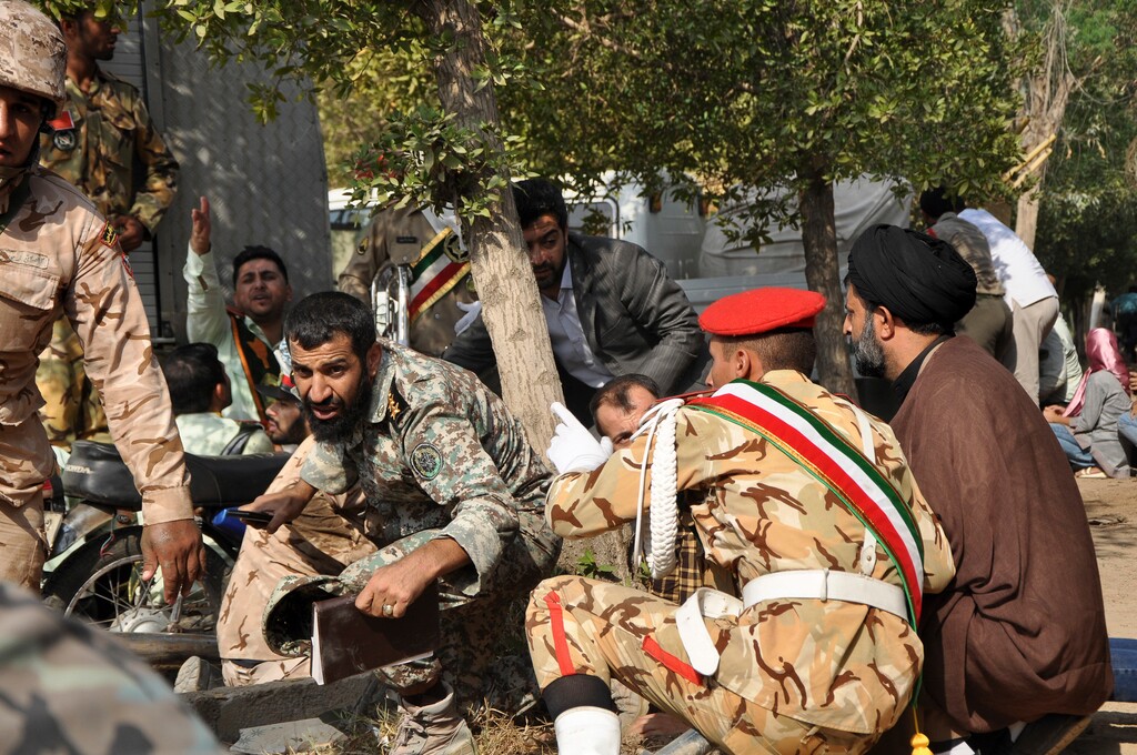 (Behrad Ghasemi | ISNA) In this photo provided by the Iranian Students' News Agency, ISNA, Iranian armed forces members and civilians take shelter in a shooting during a military parade marking the 38th anniversary of Iraq's 1980 invasion of Iran, in the southwestern city of Ahvaz, Iran, Saturday, Sept. 22, 2018. Gunmen attacked the military parade, killing at least eight members of the elite Revolutionary Guard and wounding 20 others, state media said.
