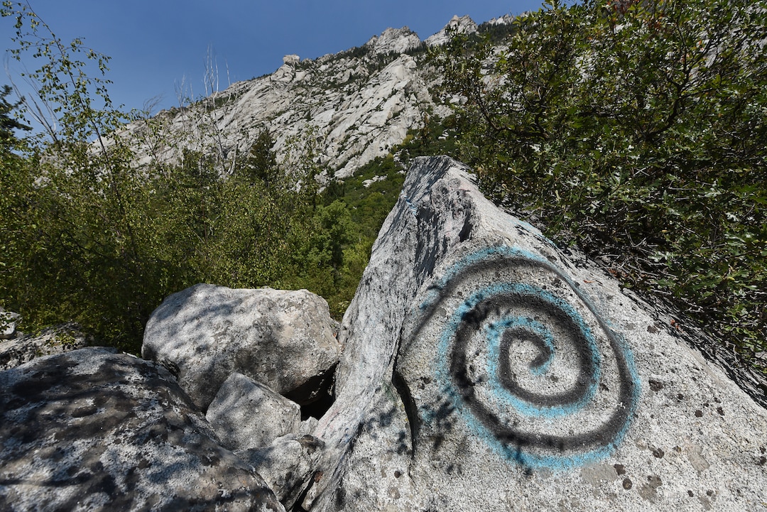 (Francisco Kjolseth  |  The Salt Lake Tribune)  Graffiti has proliferated in lower Little Cottonwood Canyon, where vandals, often wielding cans of fluorescent-colored spray paint, have covered granite faces, trees and structures. The vandalism is particularly apparent along the Temple Quarry Trail and the creek at the Moon Rock swimming hole and former pavilion site. Volunteers using donated equipment and solvents spend thousands of hours removing the paint from the rocks only to see graffiti return to the same faces or on rock nearby.
