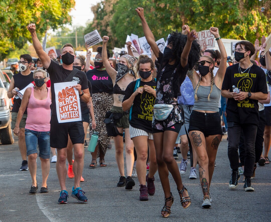 (Rick Egan  |  The Salt Lake Tribune)     Protesters dance through the neighborhood in Rose Park, during the Dance Dance for Revolution protest for racial equality, on Sunday, Aug. 23, 2020. The protest was in memory of Jovany Mercardo who was shot last August by Ogden police by four officers, hitting his body sixteen times.
