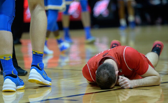 (Francisco Kjolseth  |  The Salt Lake Tribune)  Utah Utes forward David Collette (13) injures his leg as the University of Utah hosts UCLA in NCAA basketball at the Huntsman Center in Salt Lake City, Thursday, Feb. 22, 2018.