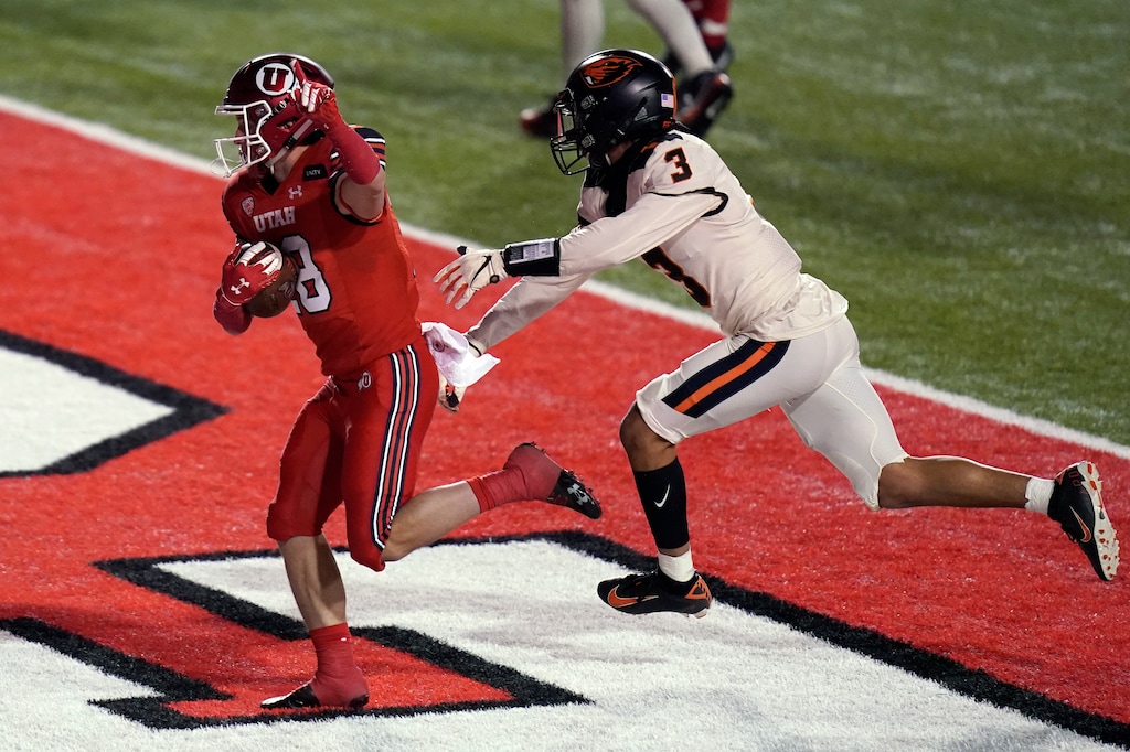 Utah wide receiver Britain Covey (18) scores against Oregon State defensive back Jaydon Grant (3) during the second half of an NCAA college football game Saturday, Dec. 5, 2020, in Salt Lake City. (AP Photo/Rick Bowmer)