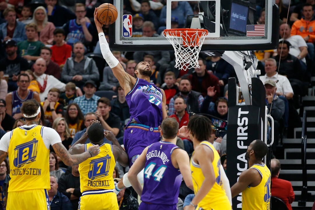 Utah Jazz center Rudy Gobert (27) scores against the Golden State Warriors in the first half during an NBA basketball game Friday, Nov. 22, 2019, in Salt Lake City. (AP Photo/Rick Bowmer)