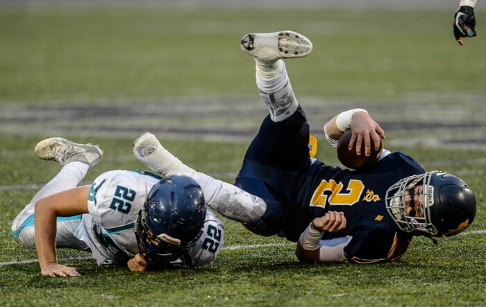 (Trent Nelson | The Salt Lake Tribune)  Summit Academy quarterback Haden Reynolds is brought down by Juan Diego's Tristen Tonozzi. Summit Academy faces Juan Diego High School in a class 3A state semifinal football game at Weber State University's Stewart Stadium, Saturday November 4, 2017.