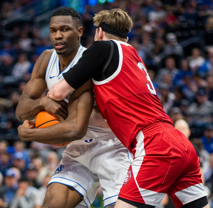 (Rick Egan | The Salt Lake Tribune)  South Dakota Coyotes guard Max Burchill (3) ants on to the ball after the whistle along with Brigham Young Cougars forward Atiki Ally Atiki (4), in basketball action between the Brigham Young Cougars and the South Dakota Coyotes, at Vivint Arena, in Salt Lake City, on Saturday, Dec. 3, 2022.
