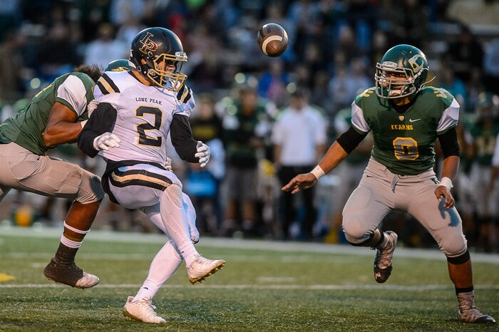 (Trent Nelson | The Salt Lake Tribune) Kearn's Audrick Afatasi moves in for the interception as Lone Peak's Brigham Trowbridge can't hold on to the pass as Kearns hosts Lone Peak, high school football, Thursday September 14, 2017.
