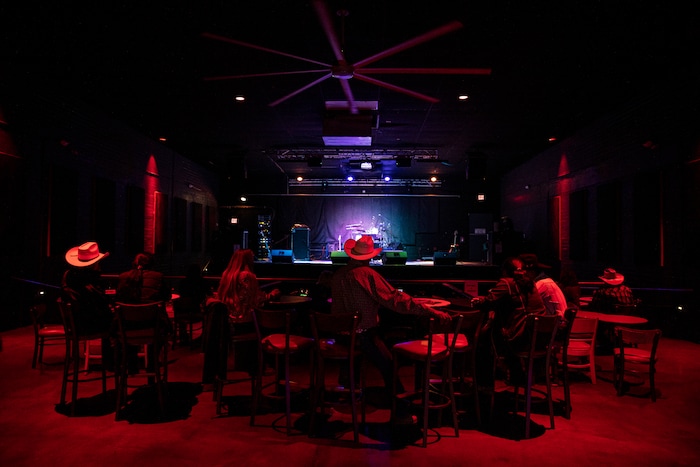 (Adriana Zehbrauskas | The New York Times) The audience arrives for Stateline, a Navajo country band, to perform at Club Red in Mesa, Ariz., Nov. 16, 2019. At highway honky-tonks, casino lounges and far-flung dance halls, a form of music that many associate with rural white America is flourishing in the heart of Indian country, and no tribe have put their own stamp on country music quite like the Navajo.