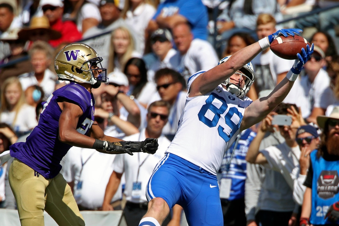 BYU tight end Matt Bushman (89) catches the ball as Washington defensive back Keith Taylor (27) defends during the  first half of an NCAA college football game, Saturday, Sept. 21, 2019, in Provo, Utah. (AP Photo/George Frey)