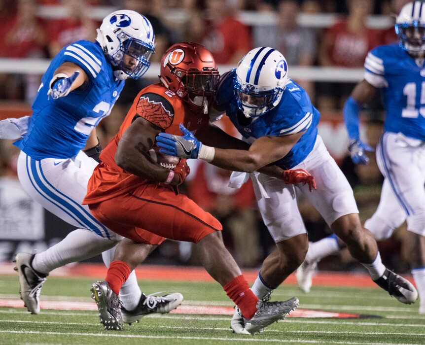 Rick Egan | The Salt Lake Tribune
Brigham Young Cougars linebacker Harvey Langi (21) and Brigham Young Cougars linebacker Fred Warner (4) try to stop Utah Utes running back Zack Moss (2), in football action, at Rice-Eccles Stadium, Saturday, September 10, 2016.