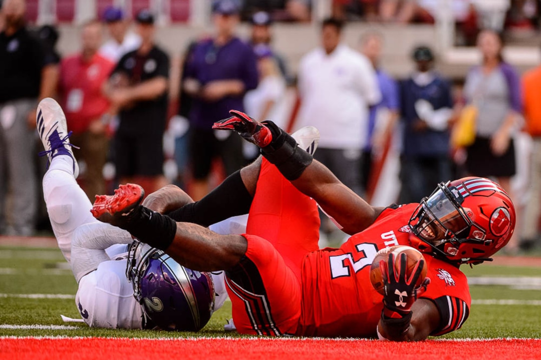 (Trent Nelson | The Salt Lake Tribune)  Utah Utes running back Zack Moss (2) is stopped just short of the end zone by Weber State Wildcats safety Jawian Harrison Jr. (2) as the University of Utah Utes host the Weber State Wildcats, Thursday Aug. 30, 2018 at Rice-Eccles Stadium in Salt Lake City.