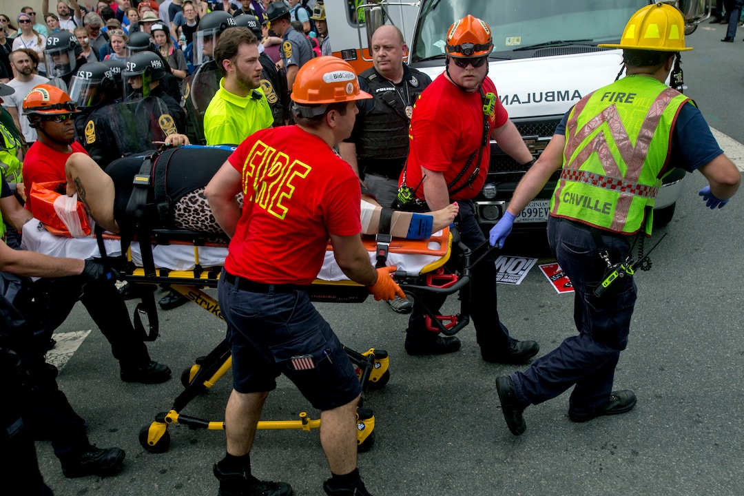 An injured person is taken away by Emergency Medical Services workers after a car ran into pedestrians during a white nationalist rally, Saturday Aug. 12, 2017, in Charlottesville, Va. (Shaban Athuman/Richmond Times-Dispatch via AP)