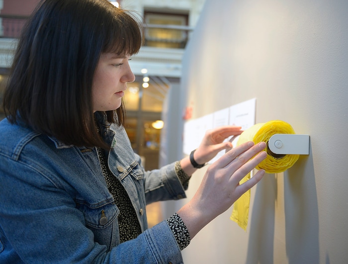 (Chris Samuels | The Salt Lake Tribune) Hannah Lutz poses for a photo with her exhibit Ensi, a redesign of a menstrual hygiene product dispenser, at a showcase for Utah Design Arts at the Rio Grande Depot in Salt Lake City, Sept. 12, 2019.