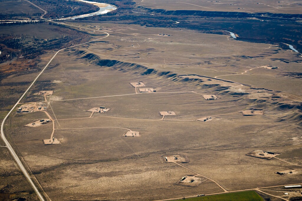 (Trent Nelson  |  The Salt Lake Tribune) The Three Rivers field west of the Ouray National Wildlife Refuge, pictured on Nov. 17, 2021, is among Utah’s most productive oil and gas fields. After a hiatus lasting more than two years, the federal government announced plans to resume leasing public land in Utah for development. This photograph was taken on a flight chartered by LightHawk.