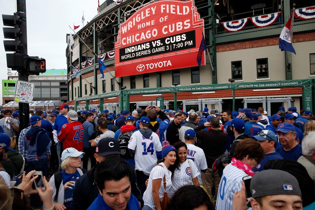 (AP Photo/Nam Y. Huh) Fans wait in front of the Wrigley Field marquee as they arrive before Game 3 of the Major League Baseball World Series between the Chicago Cubs and the Cleveland Indians, Friday, Oct. 28, 2016, in Chicago.