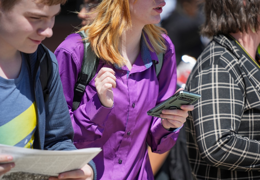 (Chris Samuels | The Salt Lake Tribune) Students leaving Granger High School in West Valley City unlock their cell phones after exiting the school’s doors, Monday, Aug. 26, 2024.