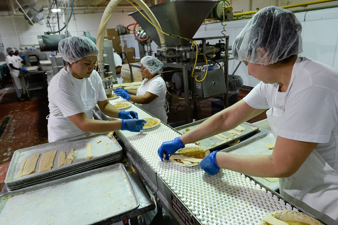 Francisco Kjolseth | The Salt Lake Tribune
Workers assemble hand laid lattice apple pie at Rocky Mountain Pie factory in Salt Lake recently. Eight different pies sold through Associated Food Stores earned blue ribbons in the commercial categories at the National Pie Championships.