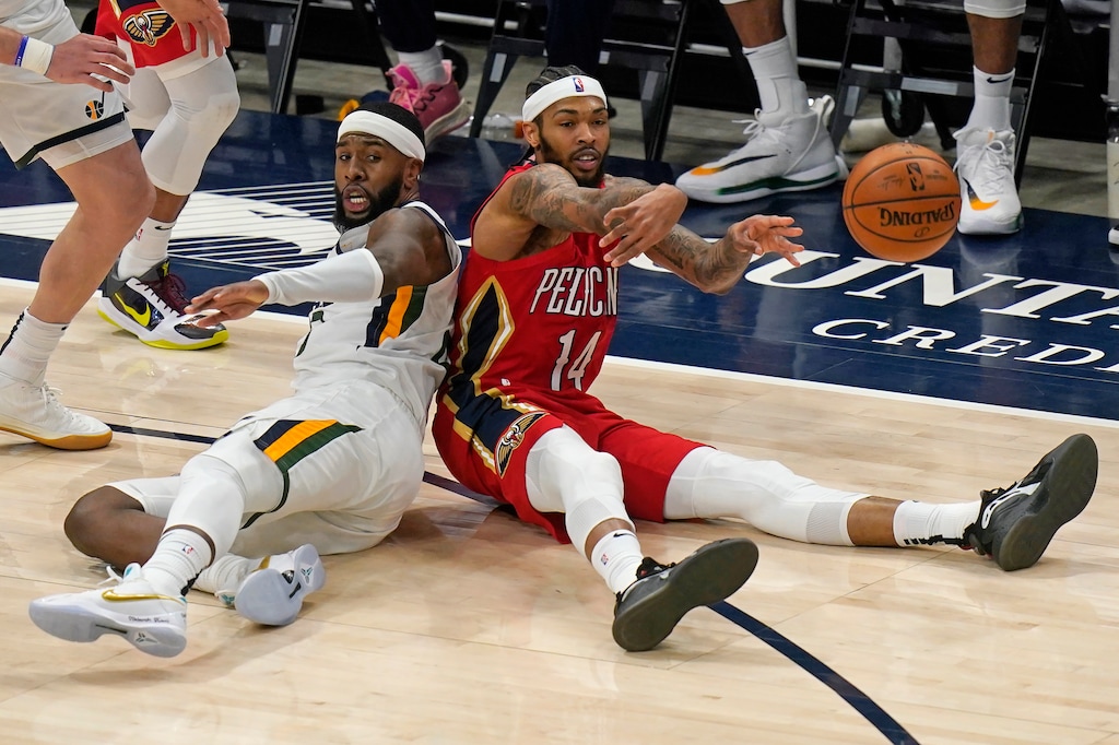 (Rick Bowmer | AP) New Orleans Pelicans forward Brandon Ingram (14) passes the ball after fighting for a loose ball with Utah Jazz forward Royce O'Neale, left, during the second half of an NBA basketball game Thursday, Jan. 21, 2021, in Salt Lake City.