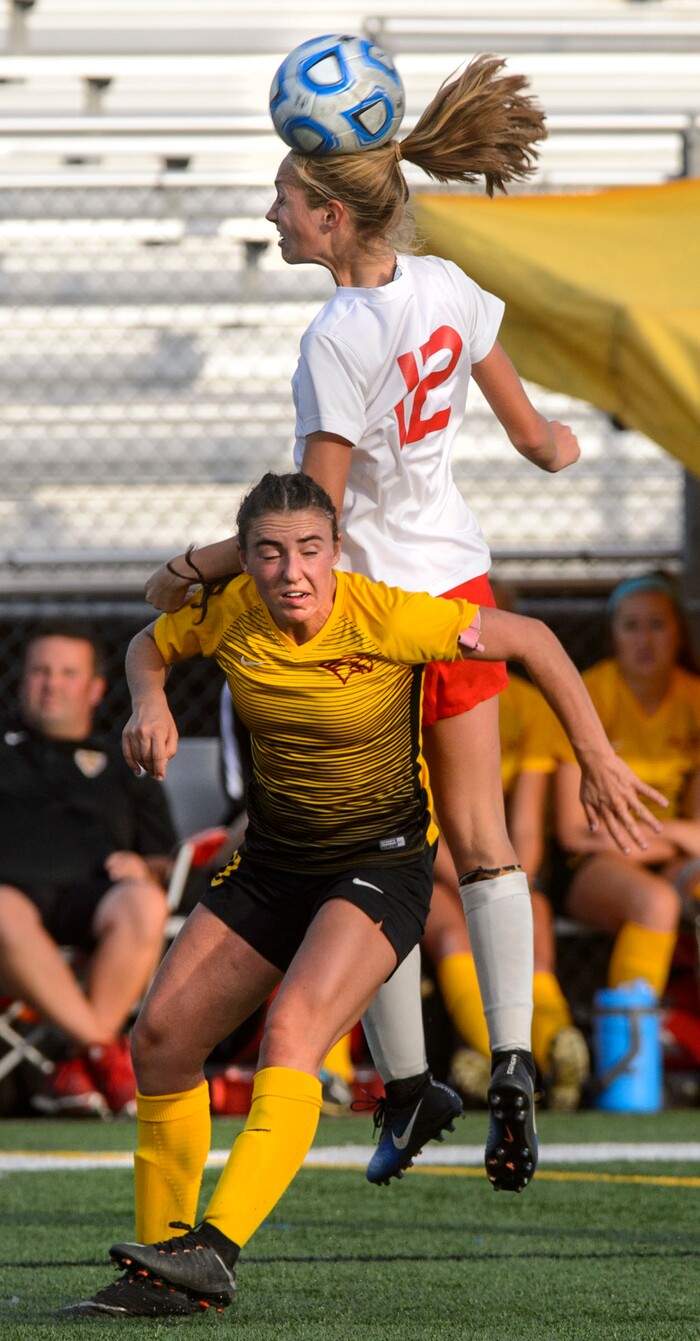 (Steve Griffin | The Salt Lake Tribune) East's Savannah Dean heads the ball away from Maple Mountain's Julia Dean during the 5A semifinal girl's soccer match at Juan Diego High School in Draper Tuesday October 17, 2017.