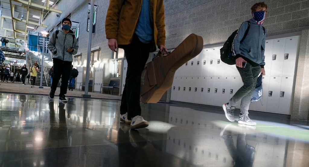 (Leah Hogsten  |  Tribune file photo) Syracuse High School students file out of school on Dec. 7, 2020. The Davis School District tried to avoid its second two-week shutdown due to COVID cases by administering rapid antigen tests to students and teachers. The Legislature is considering a bill that would provide new standards for closing schools in a pandemic with a higher threshold than are in place currently.