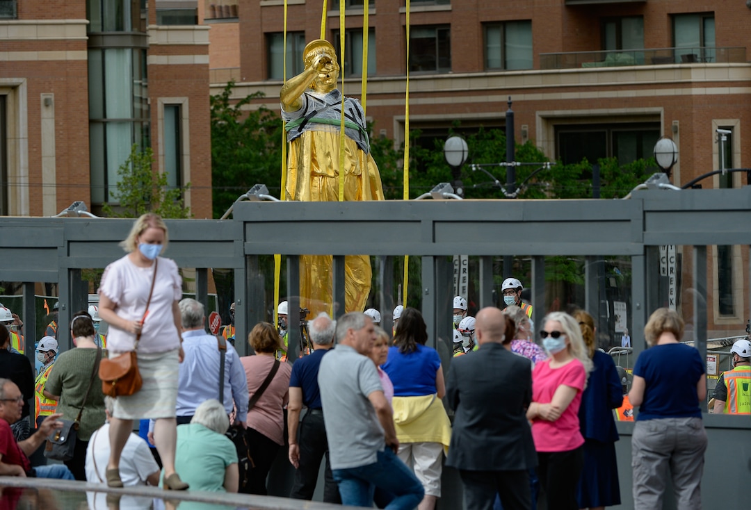 (Francisco Kjolseth  |  The Salt Lake Tribune) People gather to get a closer look of the Angel Moroni statue after it was pulled from atop the Salt Lake Temple of The Church of Jesus Christ of Latter-day Saints on Monday, May 18, 2020. The temple closed in December for seismic upgrades and sustained minor damager during the March 18, 2020, magnitude 5.7 earthquake when the trumpet held by the angel fell off and several smaller spire stones were displaced.