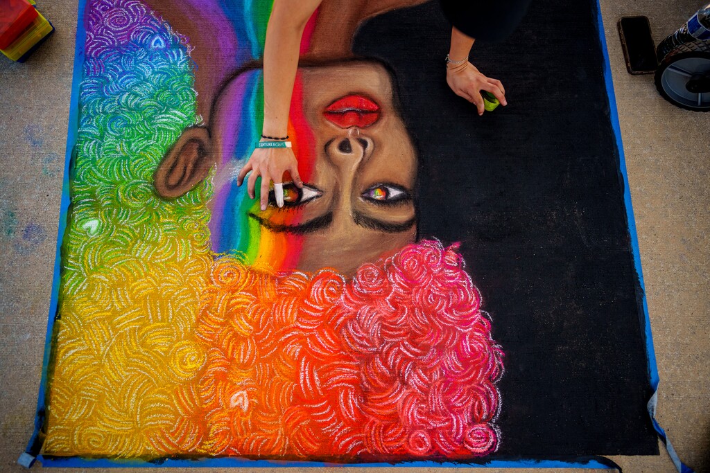 (Trent Nelson | The Salt Lake Tribune) Elena Aguilar works on chalk art at West Valley Pride, held at the Utah Cultural Celebration Center in West Valley City on Thursday, June 26, 2025.