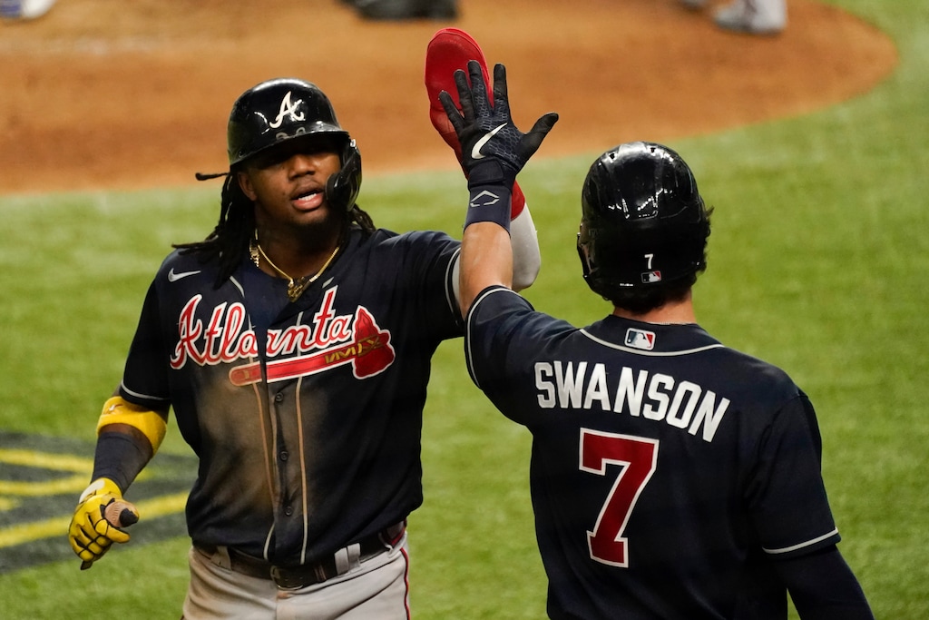 Atlanta Braves' Ronald Acuna Jr. celebrates after scoring on a walk by Travis d'Arnaud during the fifth inning in Game 2 of a baseball National League Championship Series against the Los Angeles Dodgers Tuesday, Oct. 13, 2020, in Arlington, Texas. (AP Photo/Tony Gutierrez)