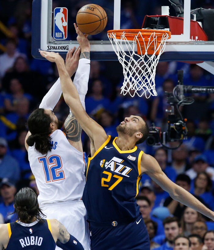 Oklahoma City Thunder center Steven Adams (12) shoots as Utah Jazz center Rudy Gobert (27) defends in the second half of Game 1 of an NBA basketball first-round playoff series in Oklahoma City, Sunday, April 15, 2018. (AP Photo/Sue Ogrocki)