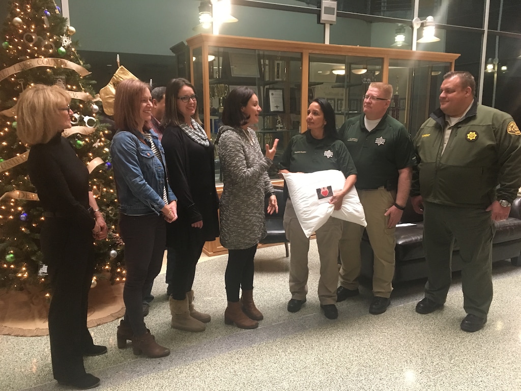 (Tiffany Caldwell | The Salt Lake Tribune) The Suite family — Annette Suite, Cassandra Suite-Smith, Celeste Suite and Sabrena Suite-Mangum — donated more than 600 pillows to the Salt Lake County jail on Friday, Dec. 22, 2017. Salt Lake County Sheriff Rosie Rivera, Lt. Brent Dietrich and Chief Deputy Matt Dumont accepted a ceremonial pillow.