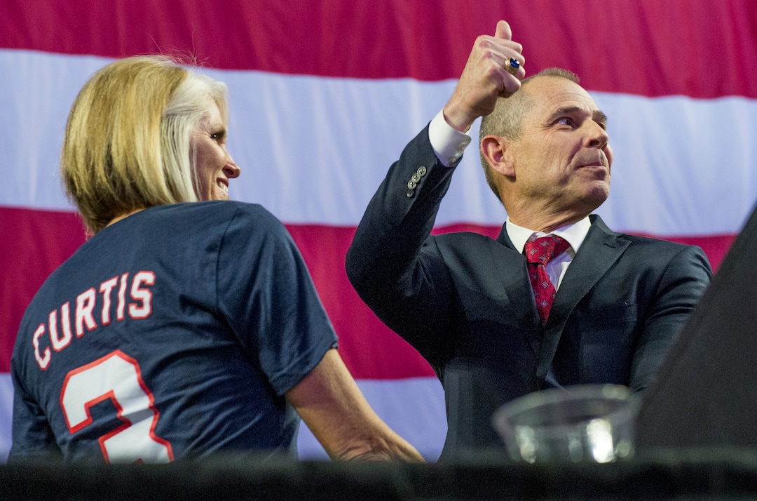 (Leah Hogsten  |  The Salt Lake Tribune) Incumbent John Curtis, of Utah's 3rd Congressional District, joined by his wife Sue, gives a thumbs up to his supporters at the Utah Republican Nominating Convention Saturday, April 21, 2018. Curtis and candidate Chris Herrod will face off in the primary. 